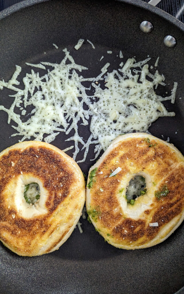 Cooking pesto egg in a bagel hole 