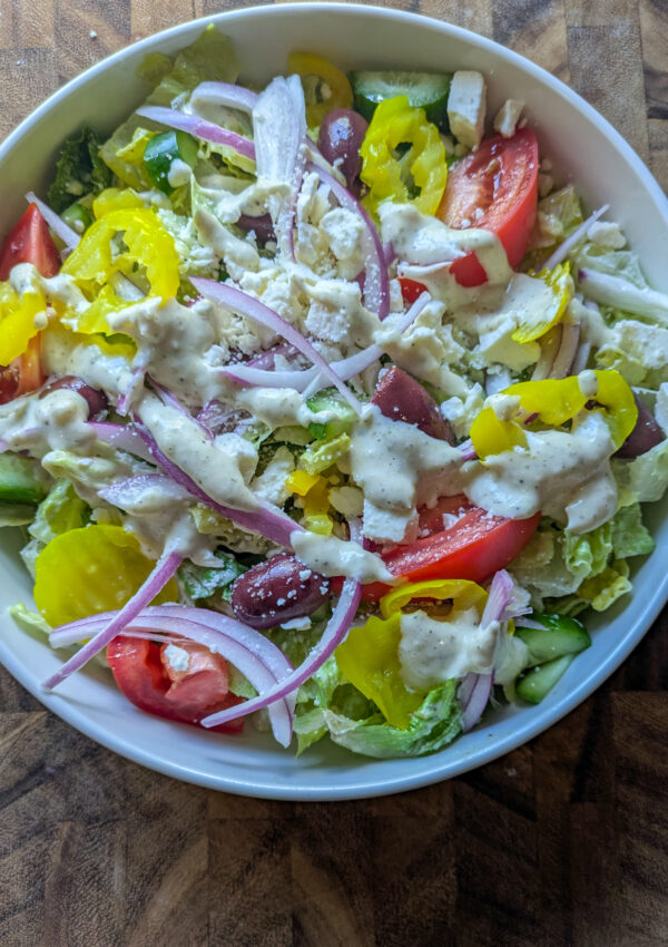 Greek salad with creamy Caesar dressing