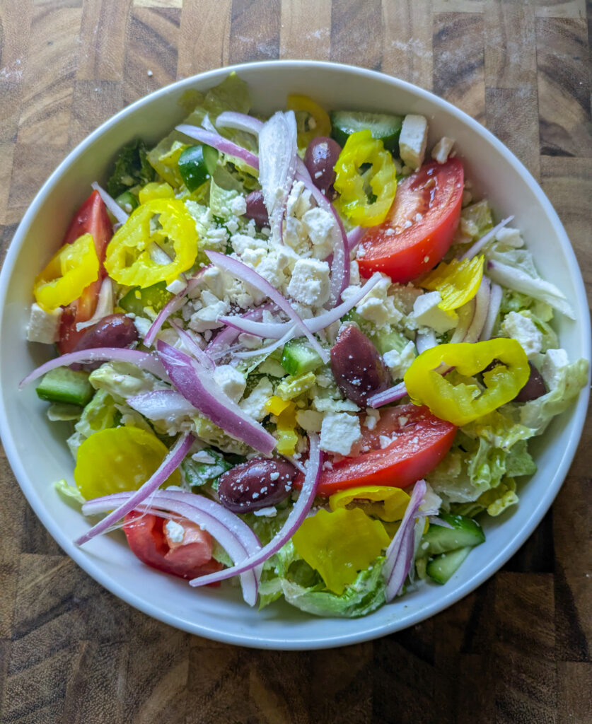 Greek salad with creamy Caesar dressing
